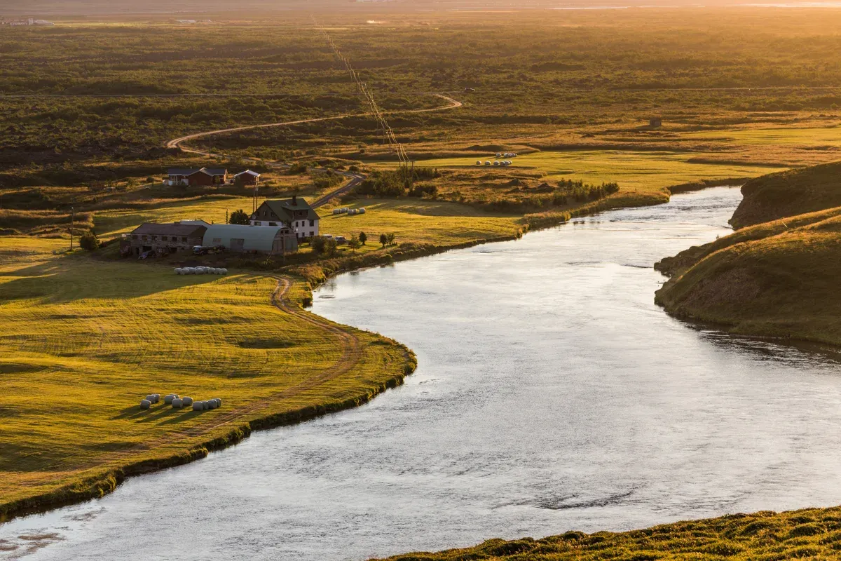 A broad river winding through the farmland of Aðaldalur in North Iceland, Laxá country for trout fishing in Iceland